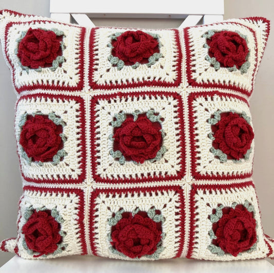 just cushions square crochet cushions with 3d red roses with green leaves on a white background